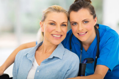 senior woman and nurse smiling